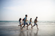 © nitinai2518 - A group of male and female friends who play fun on the white sand beach amid the blue sky.