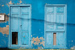 Light blue doors in dark blue wall