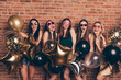 Nice-looking cool shine company attractive fascinating lovely cheerful cheery crazy overjoyed funky excited positive ladies having fun birthday isolated over industrial brick wall