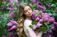 Beautiful Girl In Lilac Garden. Girl With Lilac Flowers In Springtime. Gardening.
