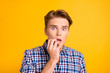 © deagreez - Close up photo amazing he him his man hold arm fingers mouth open eyes full fear oh no facial expression epic fail lost wear casual plaid checkered shirt outfit isolated yellow bright background