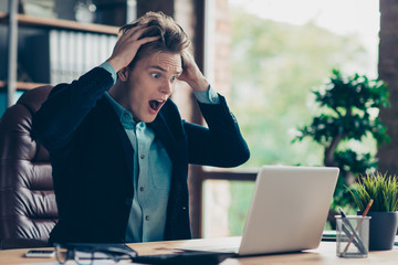 Portrait depressed frustrated disappointed man reaction omg unbelievable surprised amazed user pc wrong decision solution decide choice start-up scream sit table desk black blazer interior industrial