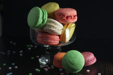 Bright macaroons against dark background	