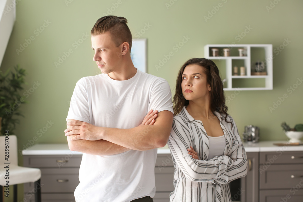 Young couple after quarrel in kitchen at home