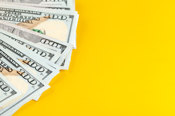 US dollar money cash on yellow background.