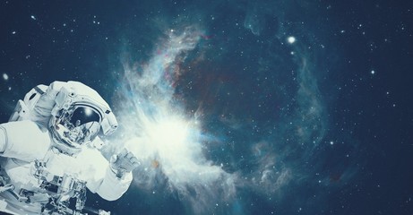 Wall Mural - astronaut in space suit in the outer space with the sunrise on planet and asteroids. elements of thi