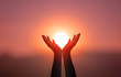 canvas print picture - Free concept: Raised hands catching sun on sunset sky