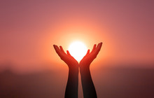 Free Concept: Raised Hands Catching Sun On Sunset Sky