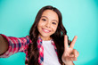 © deagreez - Self-portrait of nice attractive lovely charming cute cheerful cheery wavy-haired pre-teen girl wearing checked shirt showing v-sign isolated over bright vivid shine green blue turquoise background