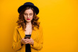 © deagreez - Close up photo beautiful she her lady concentrated arms hands telephone check instagram followers perfect modern look wear specs formal-wear costume suit isolated yellow vivid vibrant background