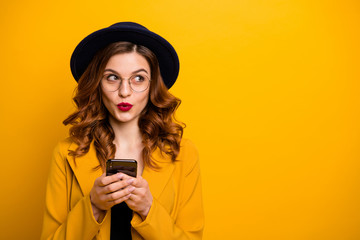 Close up photo beautiful she her lady watch sly tricky side empty space arms hands telephone reader cool news modern look wear specs formal-wear costume suit isolated yellow vibrant background