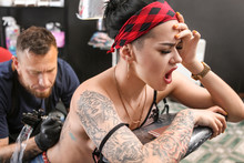 Female Client Getting Tattoo In Salon