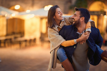 Wall Mural - Young man and woman in love flirting while enjoying on Italy .