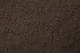 Fototapeta  - Textured ground surface as background, top view. Fertile soil