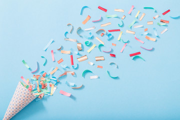 birthday hat with confetti on paper background