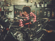 © Nejron Photo - African american woman mechanic repairing a motorcycle in a workshop