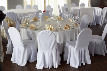 table setting, restaurant, on the table are clean appliances, white tablecloth