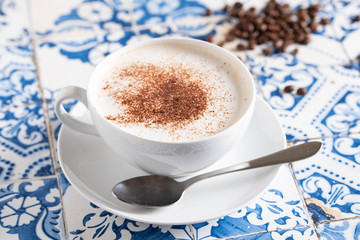 cappuccino on rustic blue tile