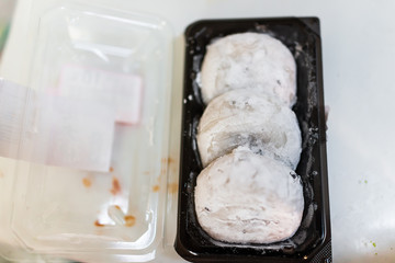 Wall Mural - Three round whole pieces of mochi sticky glutinous rice cake dessert wagashi daifuku filled with red bean adzuki jam filling storebought packaged