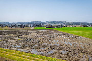 Toyama, Japan countryside with view of farmland in rural area in Gifu prefecture, Hida with brown muddy field near Hayahoshi during day