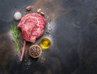 Wall Mural - Raw  Rib eye steak or beef steak on the graphite board with herbs and spices.