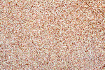 Poster - Against the background of disseminated sand small gravel, a stone crumb. Texture of a surface of a wall,light color