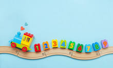 Kids Toy Train With Numbers On Toy Wooden Railway On Light Blue Background With Copy Space