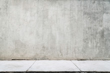 Empty Grunge Wall With A White Sidewalk.