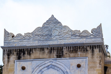 Clean shoot of old masonry stone building entrance marble ornaments on the roof