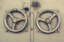 Old Golden Door Handle. The Metallic Corn-coloured Door Knob In The Shape Of Aureate Steering Wheel. Two Metallic Gold Door Handles In The Form Of Helm Close-up. Gilded Door With Two Door Round Handle