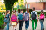 Fototapeta  - Group of kids going to school together.