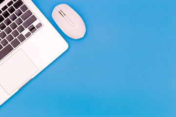 flat lay Office desk table of modern workplace with laptop on blue table, top view laptop background and copy space on blue background, blue desk office with laptop, smartphone and other work supplies