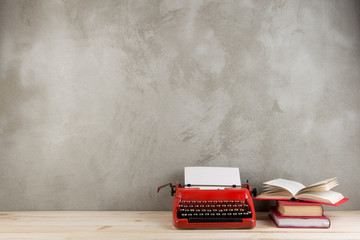Wall Mural - vintage typewriter and books on the table with blank paper on wooden desk