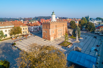 Sandomierz old city, Poland. Aerial view in sunrise light. Gothic city hall with clock tower and Renaissance attic and St Mary statue in the market Square (Rynek). One of the oldest towns in Poland.