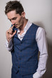 © Unique Vision - Elegant young handsome man in white shirt and vest. Studio fashion portrait.