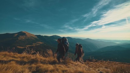 Wall Mural - the couple walking to the mountain. slow motion