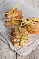 Wall Mural - Fresh Italian cookies cantuccini with almond seeds on linen napkin on ructic wooden table background.