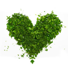 A Green Heart Of Chopped Parsley And Dill On White Background
