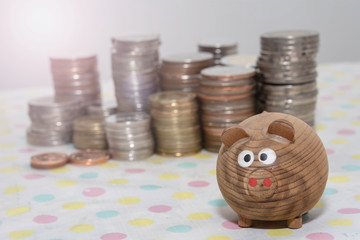 Wall Mural - Wooden pig with coin stacks background, Saving money concepts, Investment concepts