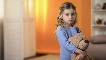 Adorable Sad Little Girl Hugging Favorite Teddy Bear Feeling Lonely In Orphanage
