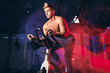 © alfa27 - Determined bare-chested sportsman engaged in a bicycle simulator in the gym, warming up before powerlifting workout