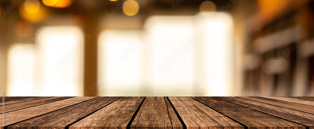 modern brown wood tabletop with blurred restaurant bar cafe light color ...