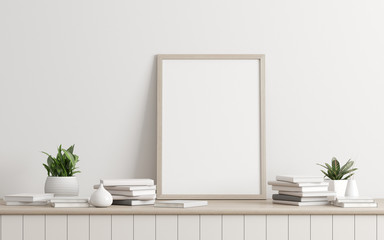 Mock-up of picture frame with small plant in vase and books on white wall. Perspective of modern Interior design. 3d rendering.