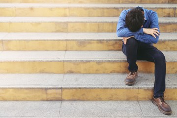 The boy sitting in front of him to receive the sad story may be caused by depression.