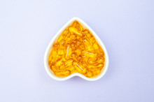 Heart-shape Plate With Fish Oil Capsules Omega 3, Healthy Product   And   Supplement  Concept Close Up,  Flat Lay