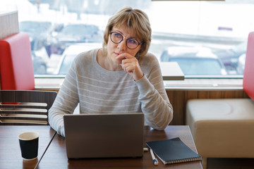 Wall Mural - woman working on laptop in cafe, office