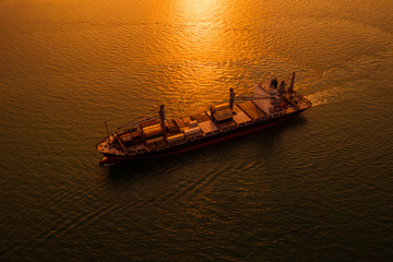 silhouette logistics shipping cargo open sea and over the sunset background