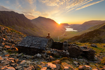 Wall Mural - Beautiful Vibrant Sunset In The English Lake District With Stone Mountain Hut.