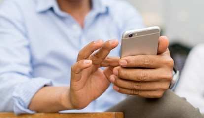 close up mature businessman checking work on smartphone at home for lifestyle people concept