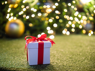 White gift box with yellow bokeh circle light background